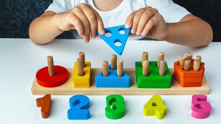 A child plays with a shape sorting toy