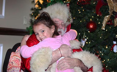 Kiddi Kollege Girl Hugging Santa Kiddi Kollege Girl Hugging Santa
