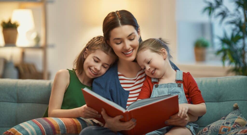 A mother reads a story to her two daughters